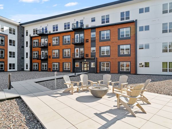 Lexi Apartments A building with a fire pit and chairs.